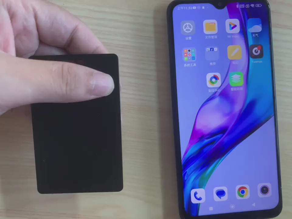 The SlimTrack Android card tucked into a wallet and tracked from a phone.